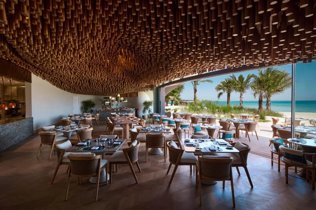 A restaurant with a view to the beach — food, beverage and service shape both operations and energy demand.
