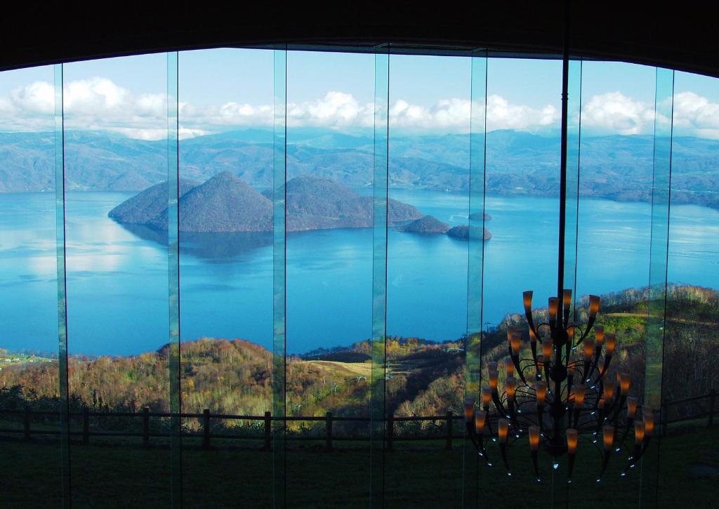 Panoramafenster mit Blick auf den Lake Tōya und seine Inseln, The Windsor Hotel Toya.